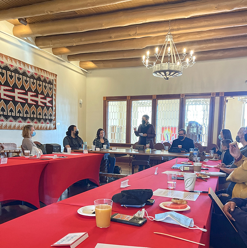 Group gathered around a conference table having a discussion